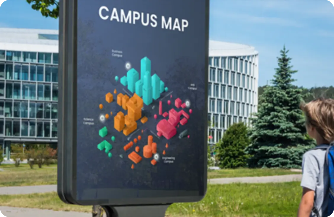 A student at a campus looking at a digital signage to find his way around the campus.