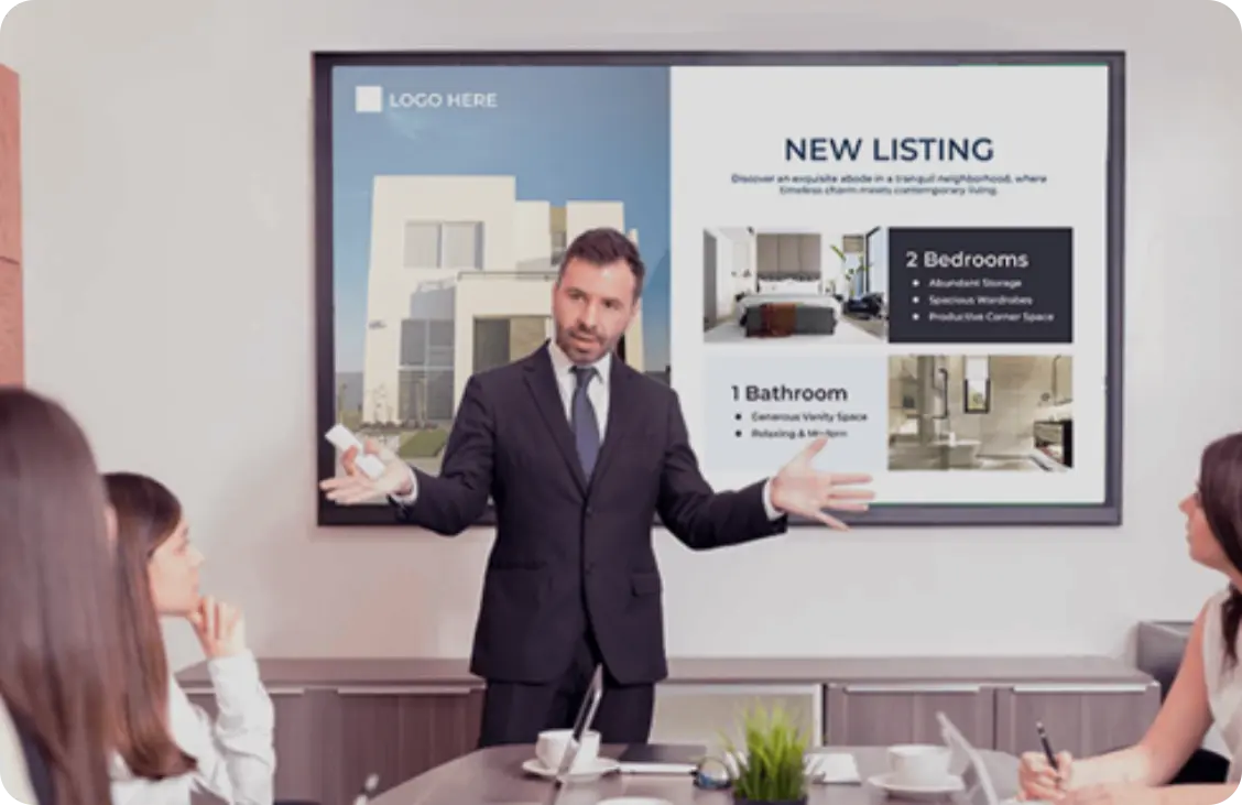 A man presenting in the conference room with his content on the screen set up by Wioplex Digital Signage Software.