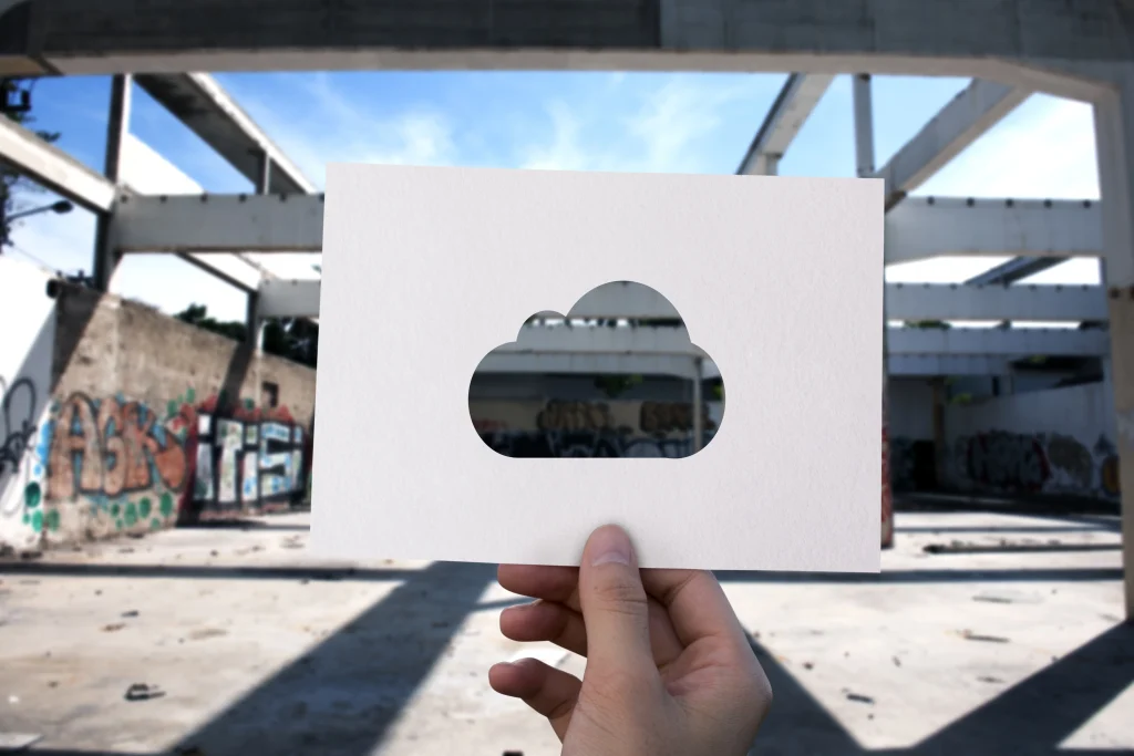 Someone holding a cut out of a cloud to represent Cloud Based.