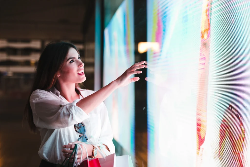 A woman looking at a digital signage connected with Wioplex